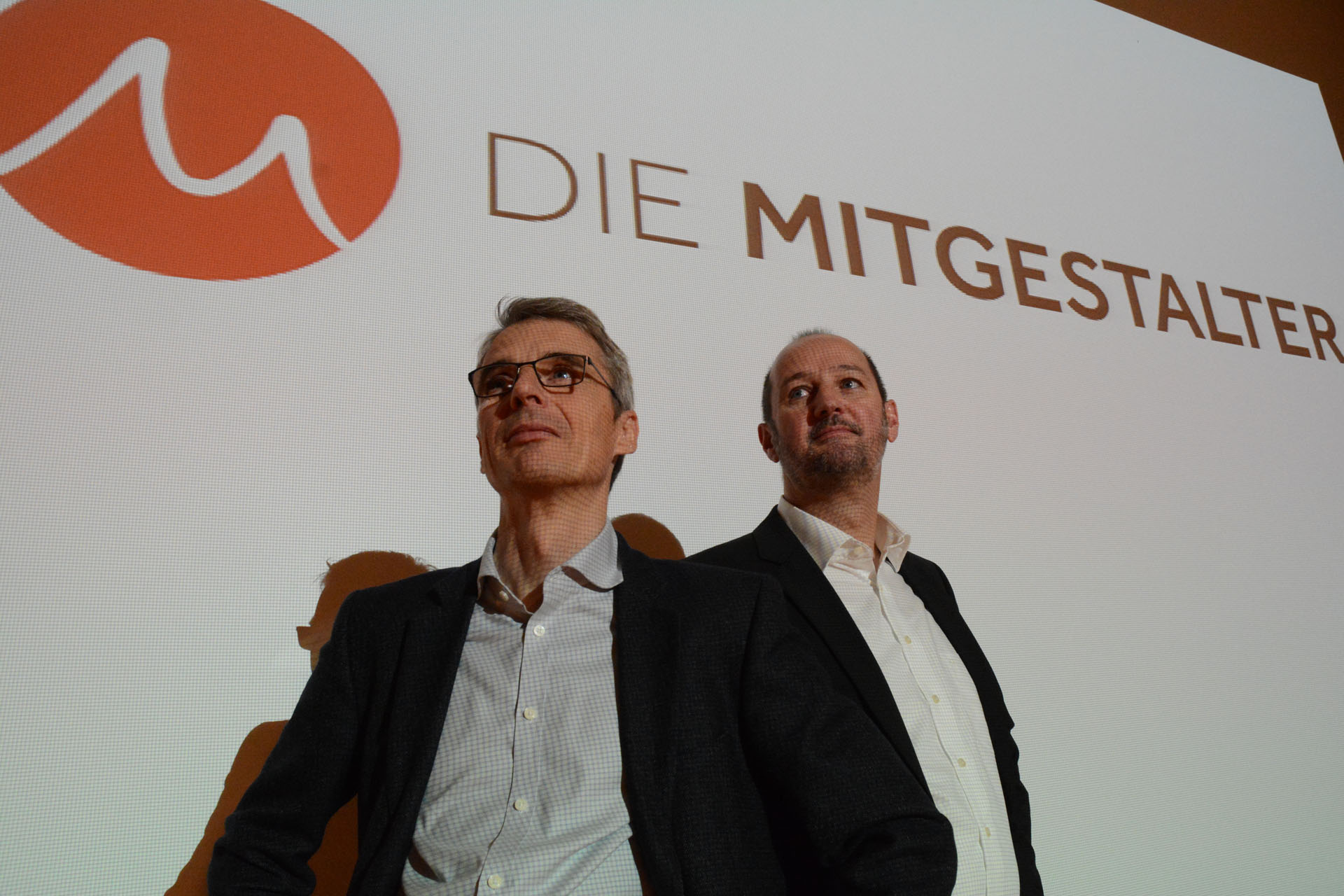 Mitgestalter vor Logo